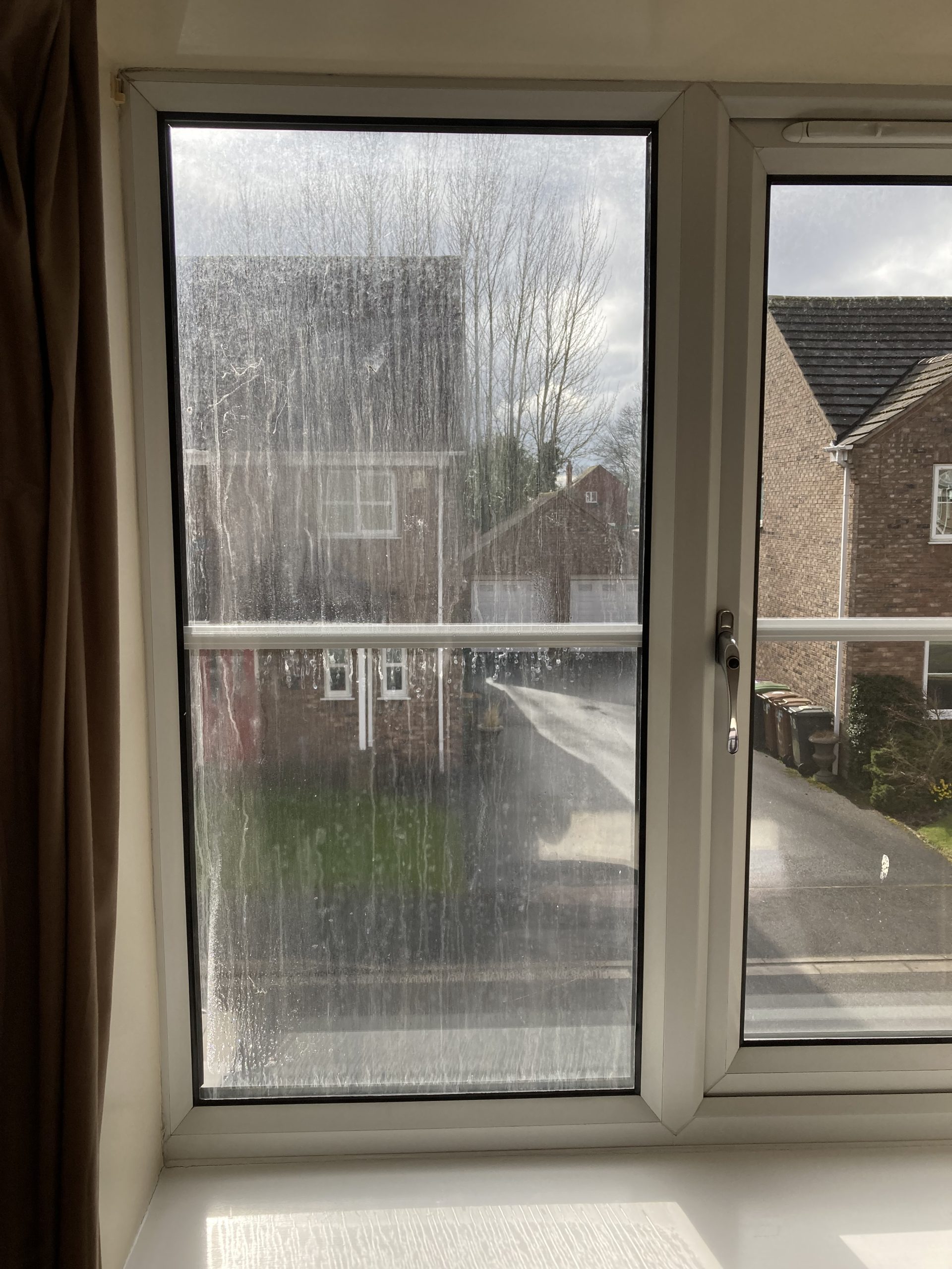 A blown window pane in the first floor of a home