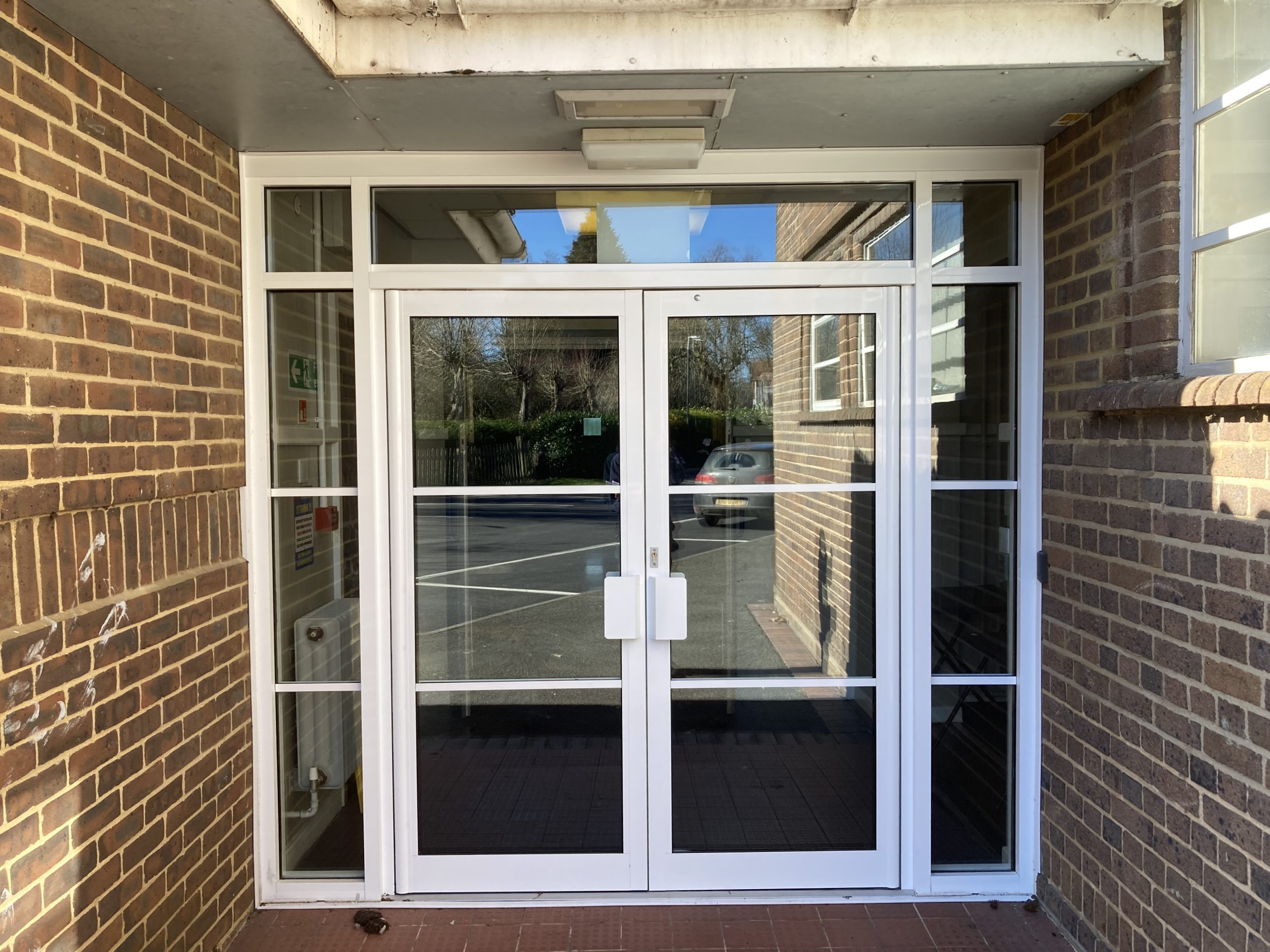 New secure closed double doors for education facility in clean white