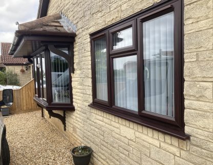 Traditional dark wood effect windows and matching guttering and soffits