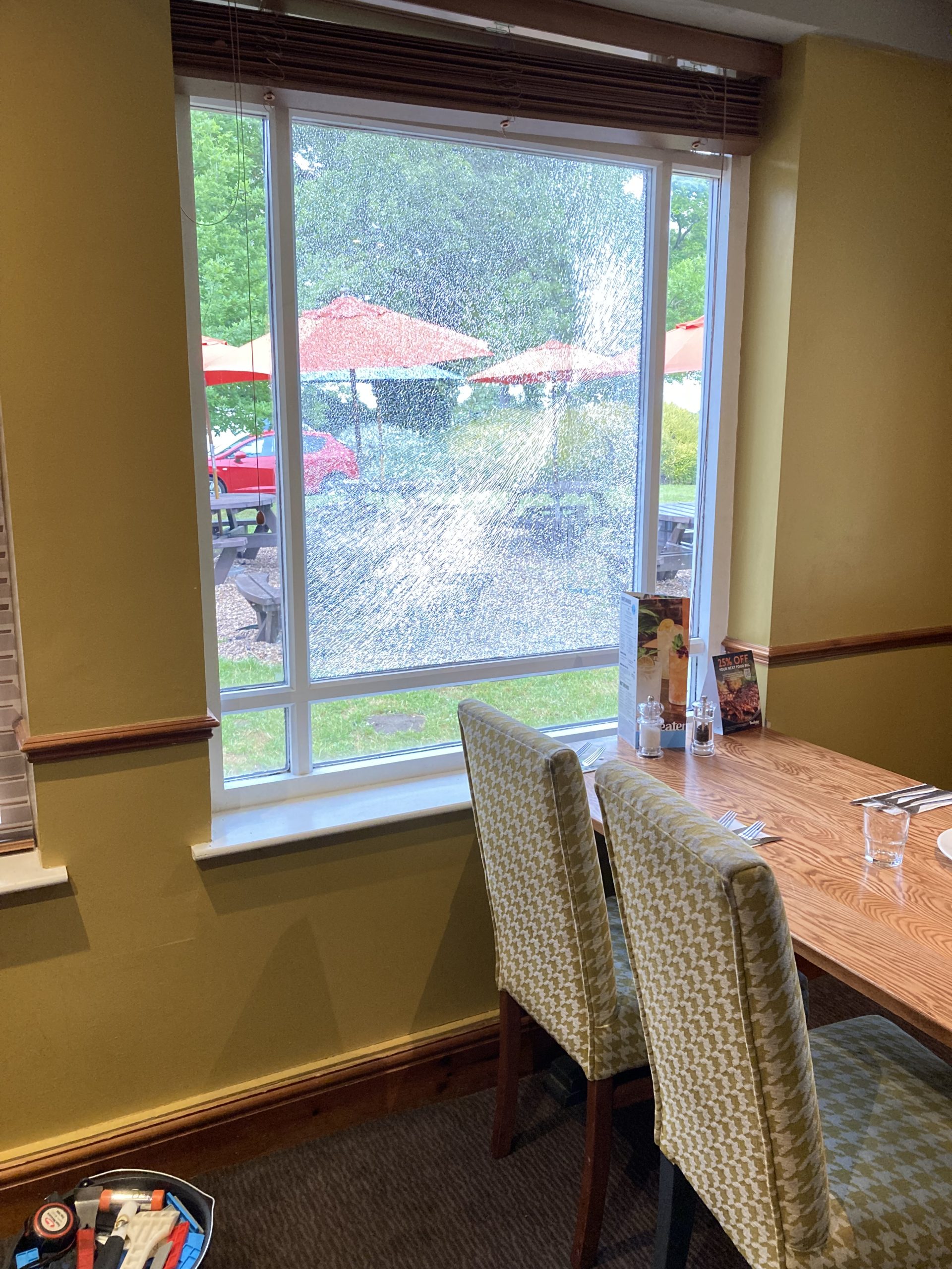 A broken window at a pub before removal and replacement by Taurus boston