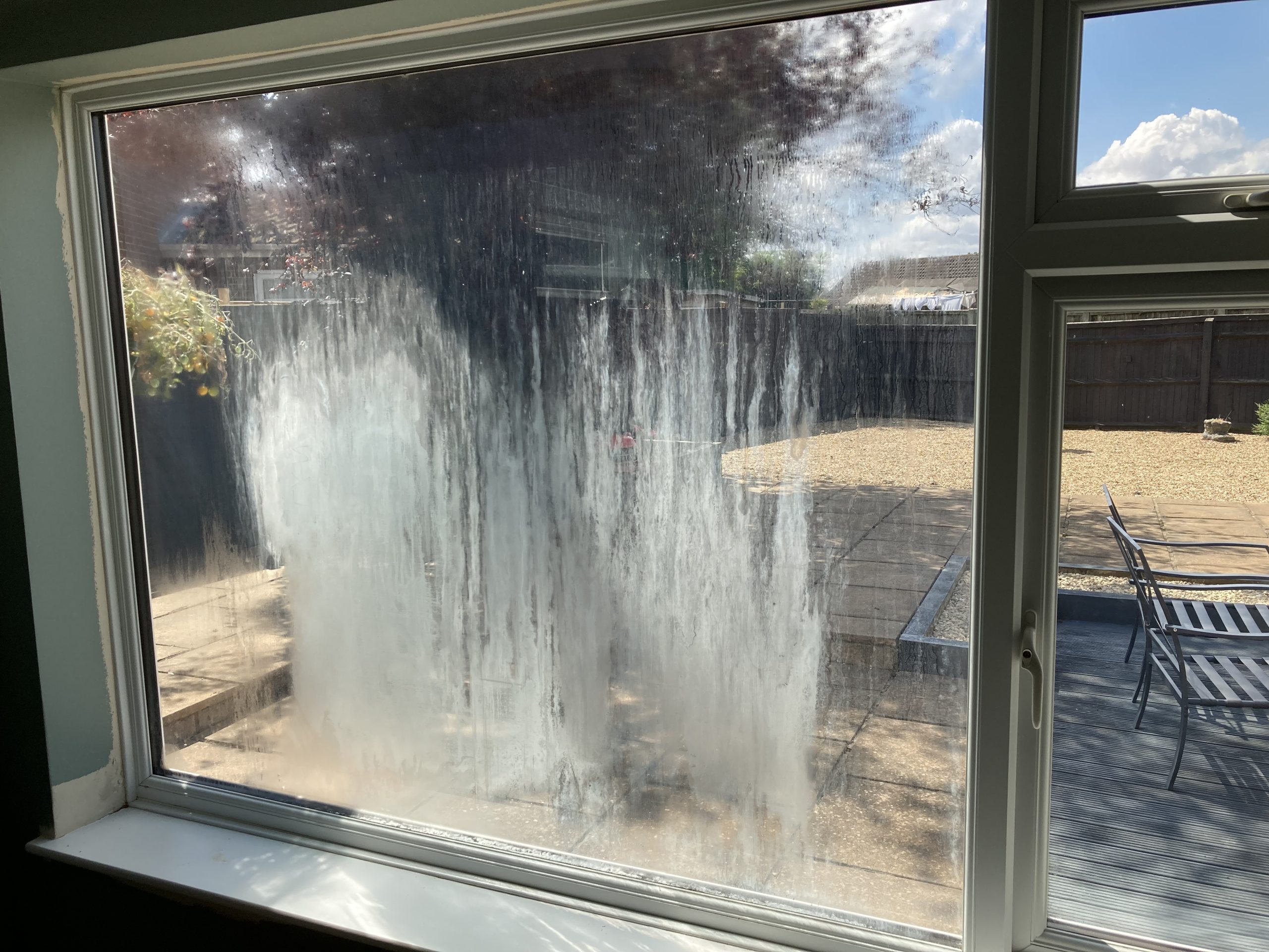 A blown old window pane with steam and condensation before successful replacement by Taurus Boston