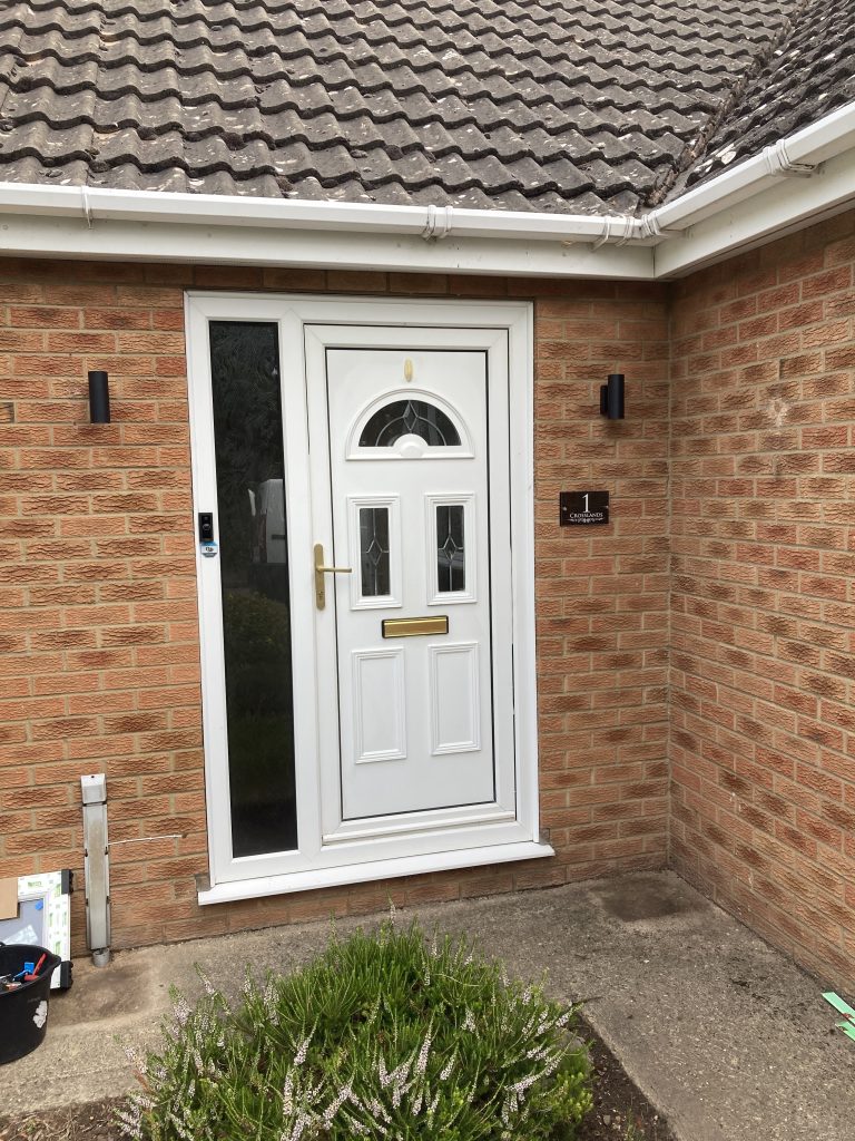 UPVC front door and glazed side panel in white