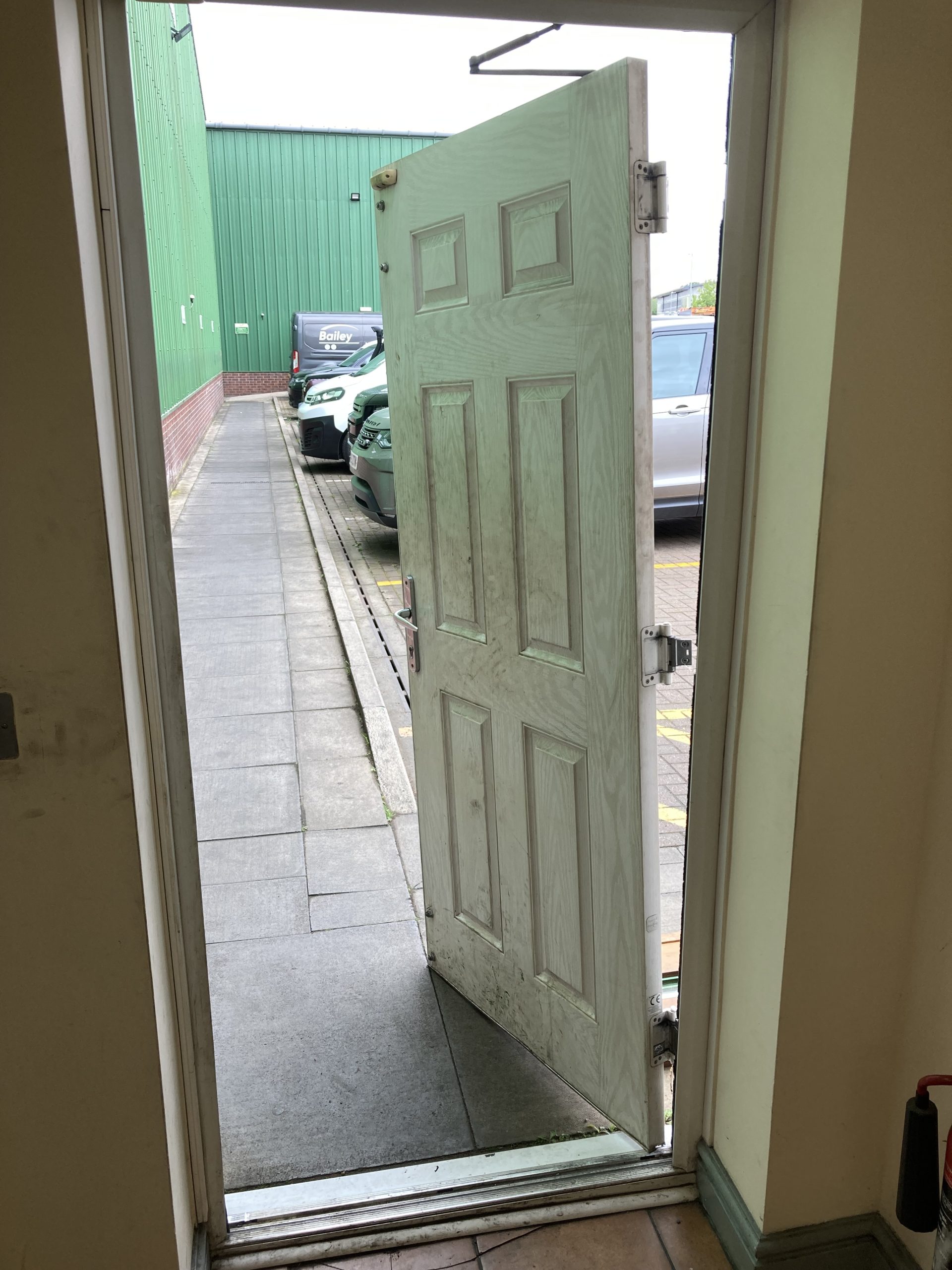 A door being removed for replacement by Taurus Locks and Glazing, Boston.