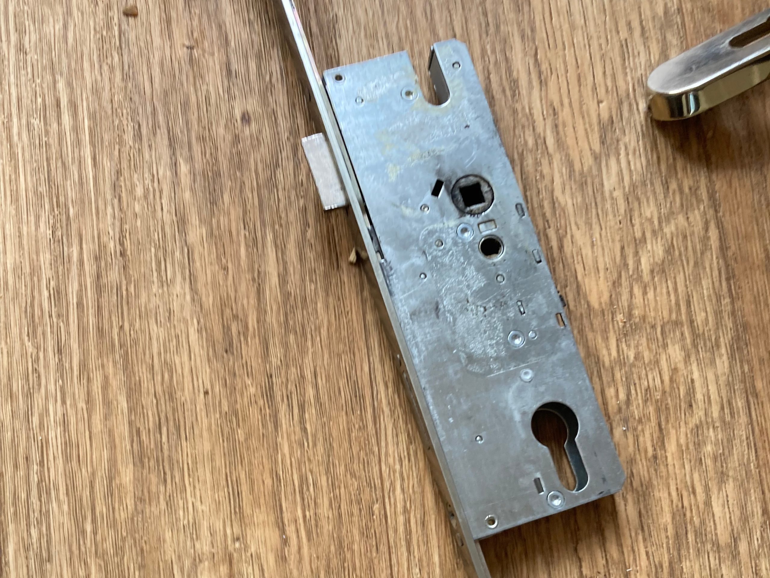 A door lock with keyhole, placed on a desk.