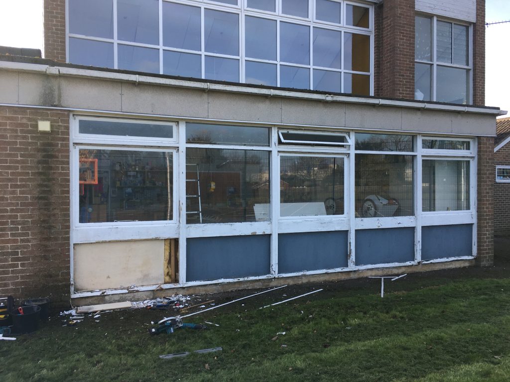 Old school building windows during removal by Taurus Boston